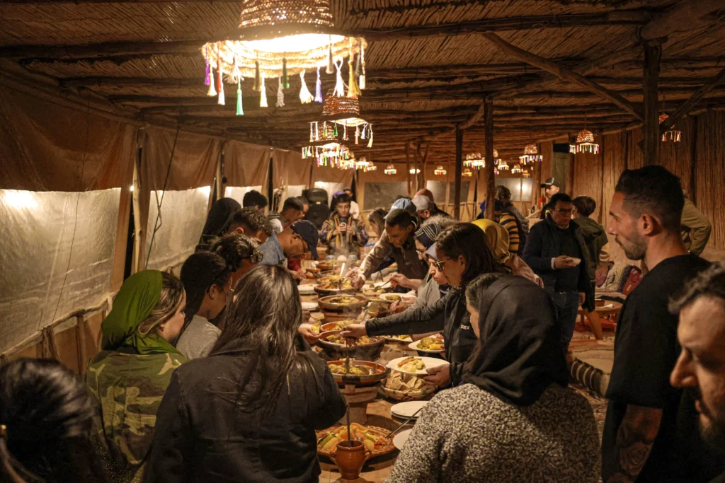 Guests enjoying Moroccan dinner buffet at Agafay Oasis Sky luxury desert camp