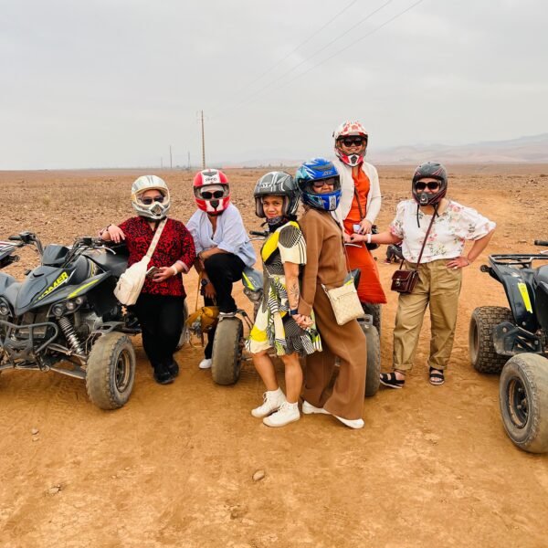 Client enjoying breathtaking sunset over Agafay Desert at Agafay Oasis Sky in Marrakech, with golden skies and desert views.
