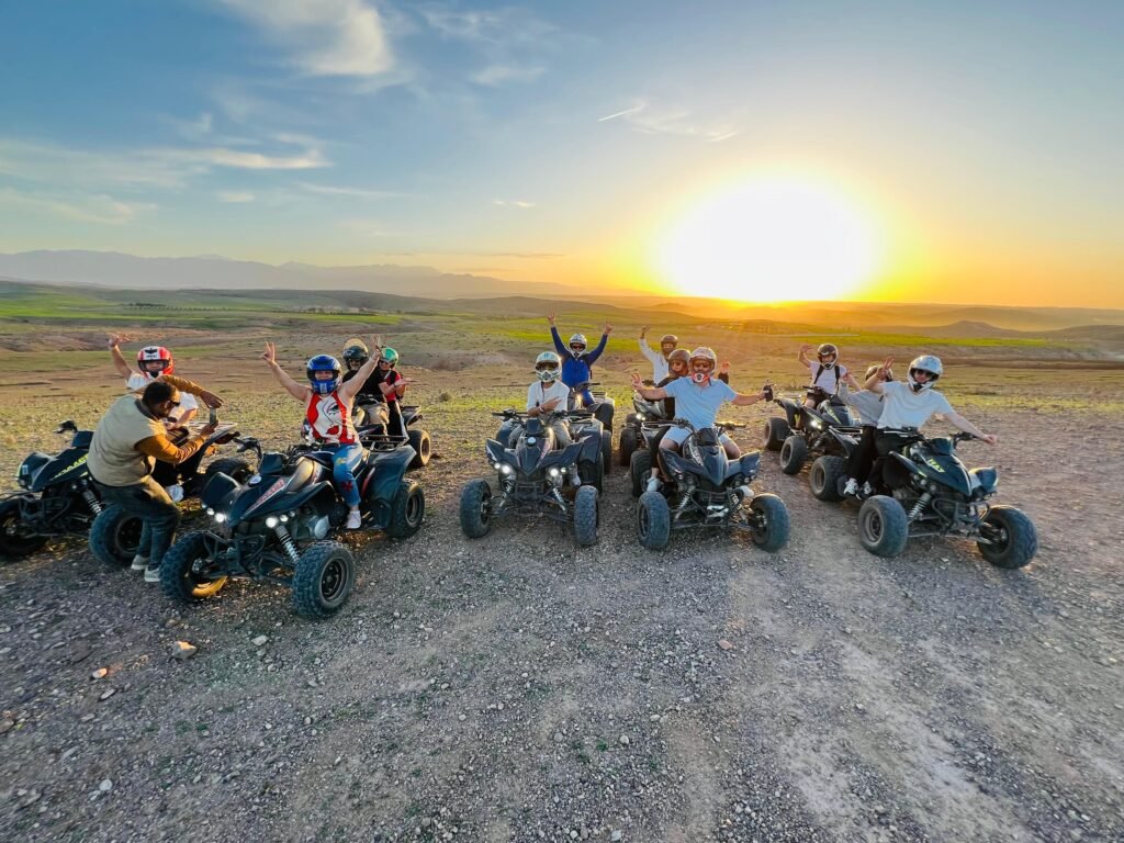 Happy travelers riding quad bikes in the Agafay Desert with Oasis Sky near Marrakech during an exciting desert adventure.