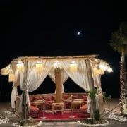 Lantern-lit Moroccan dinner setting beneath the stars at an Agafay Desert camp near Marrakech