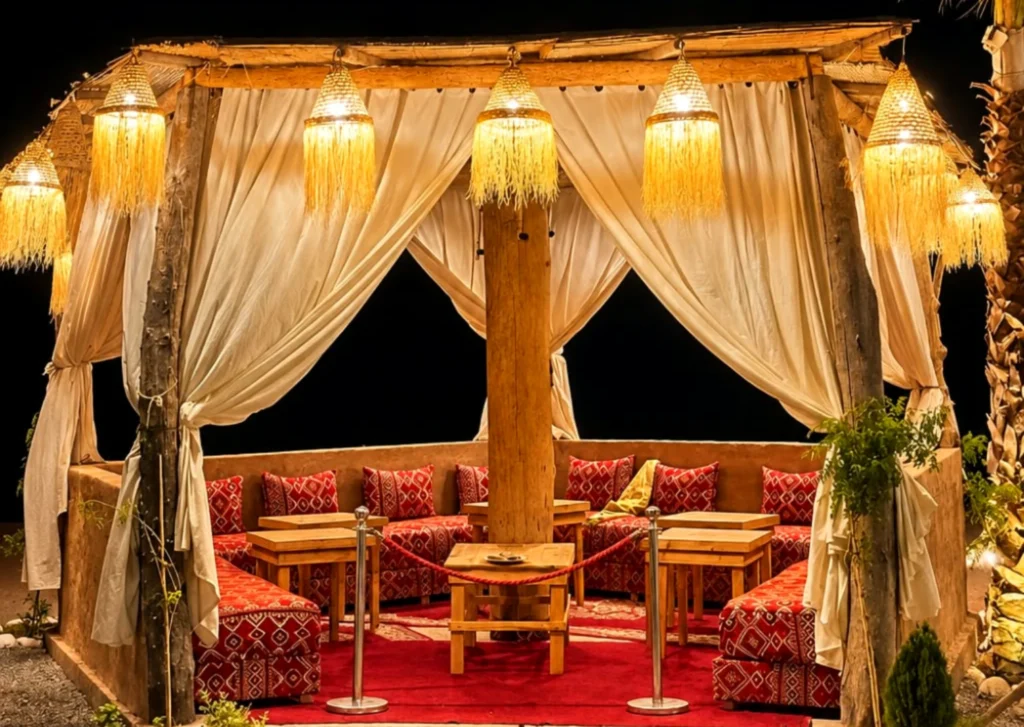 Illuminated private pergola dining area at night in the Agafay Desert