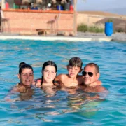 Guests relaxing by the Oasis Sky swimming pool in Agafay Desert near Marrakech